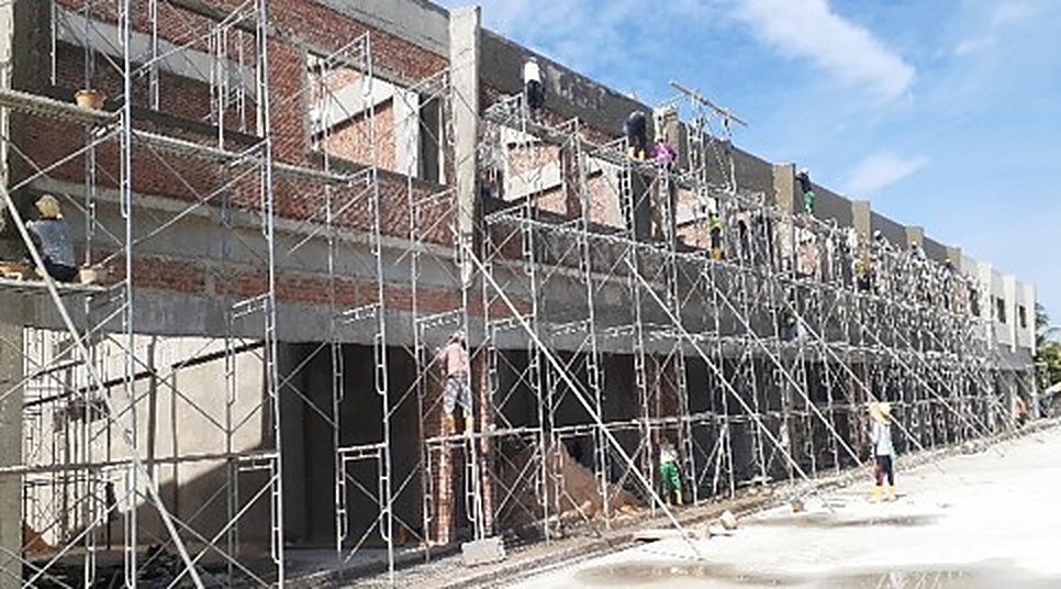 Row of terrace units under scaffold